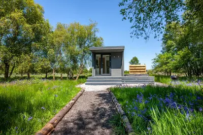 a small house in the middle of a field at The Stag, Luxury pod with hot tub, Croft4glamping in Oban