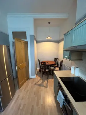 a kitchen with a table and a dining room at Sauchiehall Street West End Apartment in Glasgow