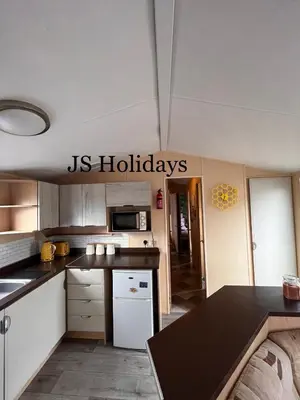 a kitchen with a us holidays sign on the wall at JS Holidays The Westmorland Lagganhouse in Ballantrae