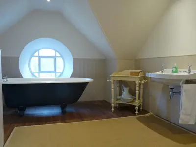 a bathroom with a large tub and a sink at The Bothy, Gallin, Glenlyon, Perthshire in Bridge of Balgie