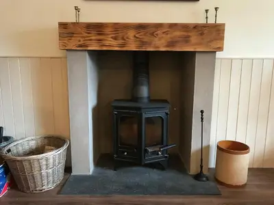 a fireplace with a wood stove in a room at The Bothy, Gallin, Glenlyon, Perthshire in Bridge of Balgie