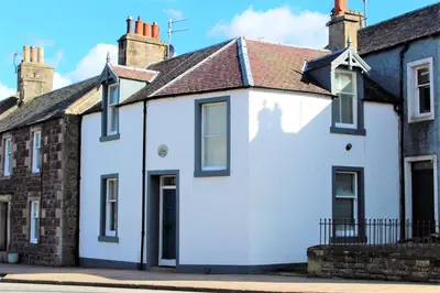 a white house with a red roof at Beeswing, a Victorian Gem in Biggar in Biggar