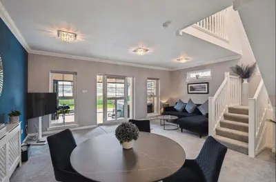 a living room with a table and a couch at Little Gleddoch in Dumbarton