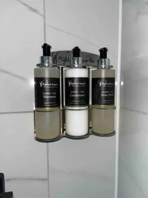 a group of three bottles on a shelf in a bathroom at Little Gleddoch in Dumbarton