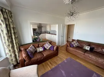 a living room with two brown leather couches at Fantastic 3 bedroom holiday home in Millport