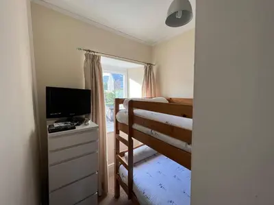 a bedroom with a bunk bed and a television at Fantastic 3 bedroom holiday home in Millport