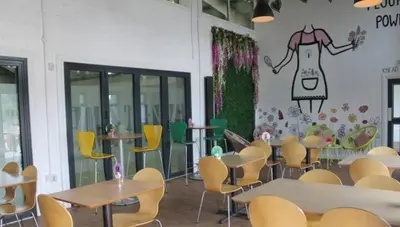 a restaurant with tables and chairs and a wall with a dress on it at Cunninghame 2 in Beith
