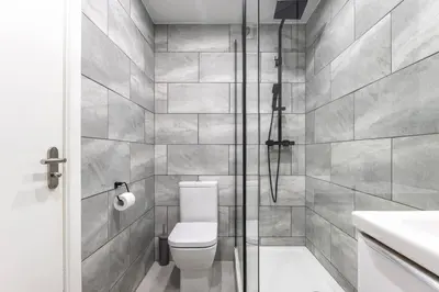 a bathroom with a toilet and a shower at ** Modern Merchant City 1 BED Apartment with Free Parking ** in Glasgow