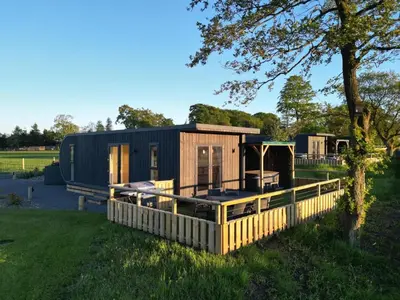 a tiny house with a porch and a fence at East Kip - Dog Friendly in Penicuik