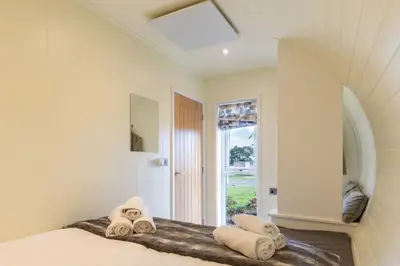 a bedroom with a bed with towels on it at East Kip - Dog Friendly in Penicuik