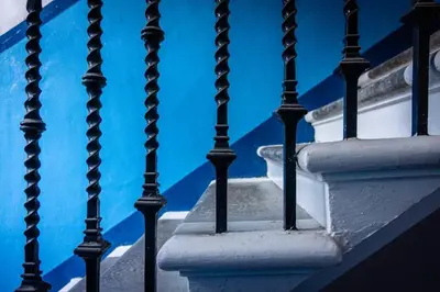 a stairway with blue water in the background at Modern bright studio apartment in south Glasgow in Glasgow