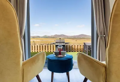 a room with a table and chairs and a window at South Black Hill in Penicuik