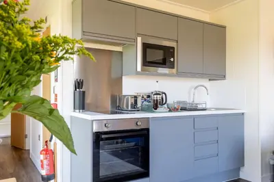 a kitchen with a stove and a sink at South Black Hill in Penicuik