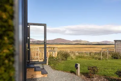 a door to a house with a view of a field at South Black Hill in Penicuik