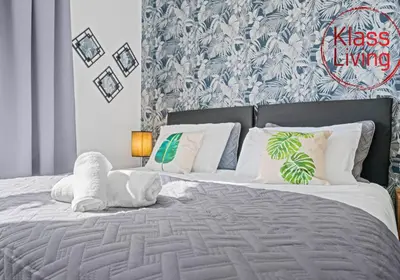 a bedroom with a large bed with white pillows at Coats Street Apartment by Klass Living Coatbridge in Coatbridge