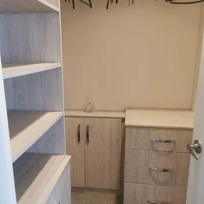 a kitchen with wooden shelves and cabinets in a room at Homeston Lodge in Drumlemble
