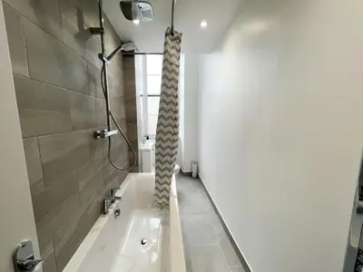 a bathroom with a bath tub and a shower at Premium 2BR Flat in the City Centre in Glasgow