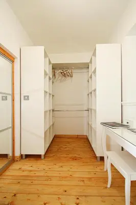 a room with white cabinets and wooden floors and a desk at Lavish 2 bed sleeps 5 near Lanark in Carstairs