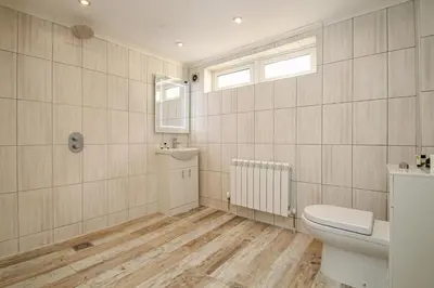 a bathroom with a toilet and a sink at Lavish 2 bed sleeps 5 near Lanark in Carstairs