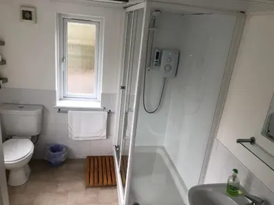 a bathroom with a tub and a toilet and a sink at Netherby Guest House Edinburgh in Edinburgh