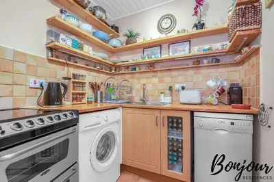 a kitchen with a dishwasher and a washer and dryer at Anvers Suite in Edinburgh
