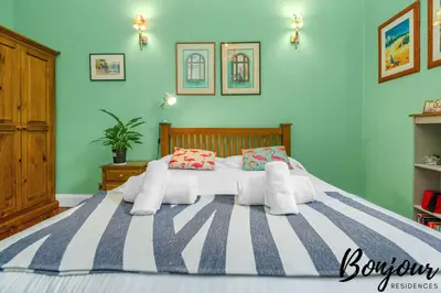 a bedroom with a large bed with blue walls at Anvers Suite in Edinburgh