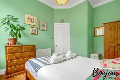 a bedroom with a bed with two towels on it at Anvers Suite in Edinburgh