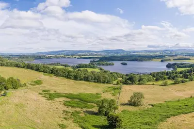 an aerial view of a lake in a field at The Mews - a cottage with a spectacular lake view in Port of Menteith