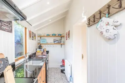 a kitchen with a sink and a counter top at The Stable - cottage with a spectacular lake view in Port of Menteith
