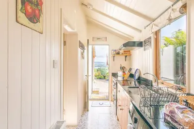 a kitchen with a sink and a counter top at The Stable - cottage with a spectacular lake view in Port of Menteith
