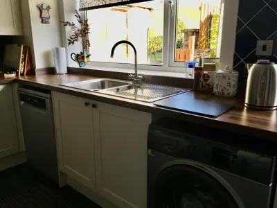 a kitchen with a sink and a washing machine at Minton cottage in Leadhills
