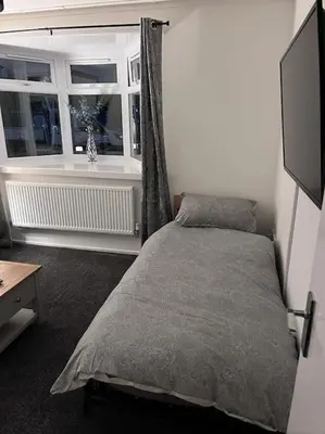 a bedroom with a bed and a window at Semi-detached chalet at Maryville Caravan Site - Uddingston, Glasgow in Uddingston