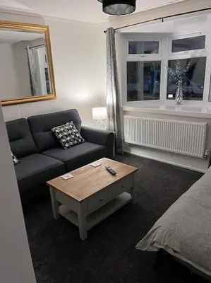 a living room with a couch and a coffee table at Semi-detached chalet at Maryville Caravan Site - Uddingston, Glasgow in Uddingston