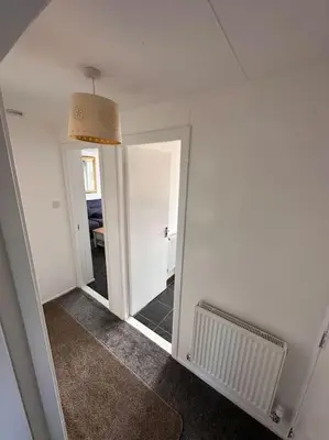 a room with a mirror and a hallway with a hallway at Semi-detached chalet at Maryville Caravan Site - Uddingston, Glasgow in Uddingston