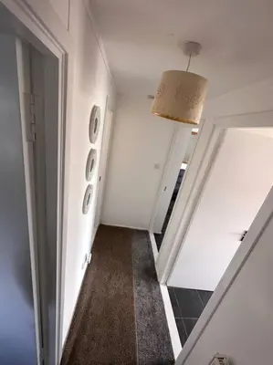 a room with a hallway with a door and a mirror at Semi-detached chalet at Maryville Caravan Site - Uddingston, Glasgow in Uddingston