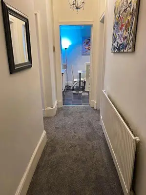 a hallway with a hallway leading to a room at Paisley Pad Glasgow Gateway second floor flat in Paisley