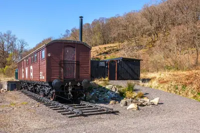 an old train car sitting on the tracks at The Carriage at Creagan in Creagan