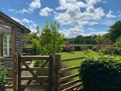 a wooden fence in front of a garden at Private detached cottage sleeps 4 in Crieff
