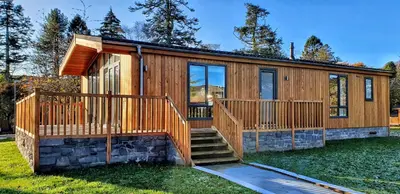a modular home with a deck and stairs at MAC Skyline Lodges in Balloch