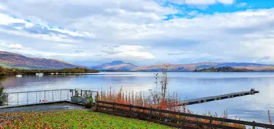 a view of a lake with a wooden dock at MAC Skyline Lodges in Balloch