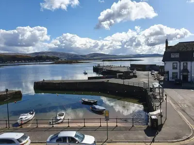 a marina with boats parked in the water at Wee Harbour View in Millport