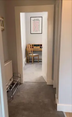 a hallway with a chair and a table in a room at 5 minutes from Loch Lomond - Newly Renovated Ground Floor 1-Bed Flat in Bonhill