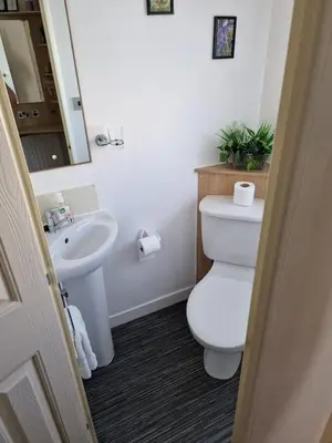a bathroom with a toilet and a sink at Just Resort No29 in Balminnoch
