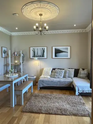 a living room with a couch and a table at Lomond View in Luss