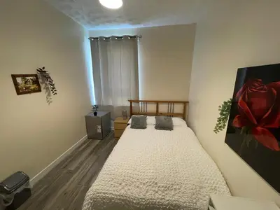 a bedroom with two beds and a window at Earls Lodge in Whiteinch