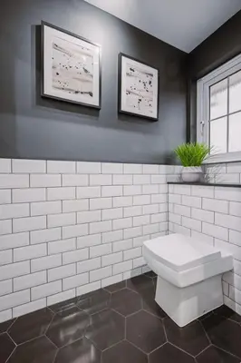 a bathroom with a white toilet and two pictures on the wall at ComfySleep ApartHOUSE in Glasgow