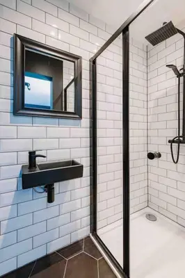 a bathroom with a shower and a sink and a mirror at ComfySleep ApartHOUSE in Glasgow