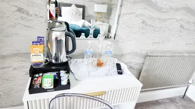 a room with a table with a blender and a mirror at Kenavara House in Oban