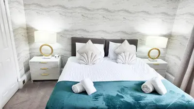a bedroom with a large bed with two night stands at Kenavara House in Oban