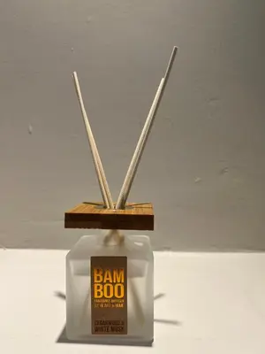a jar with sticks sticking out of it with a jam box at Cosy Cottage Apartment in Helensburgh